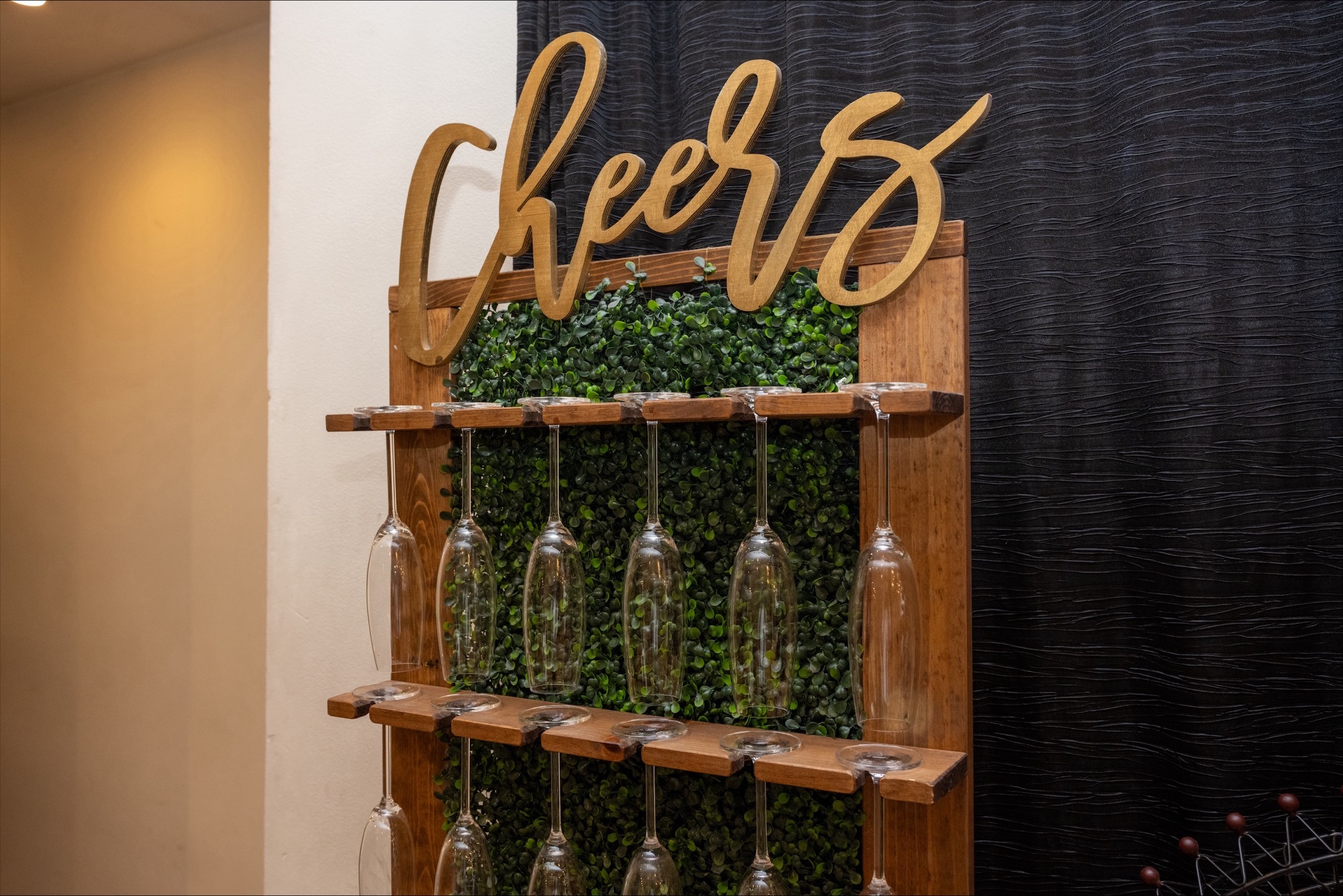 Gallery photo of a cheers display wall with hanging glasses